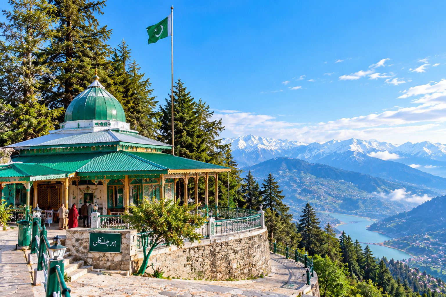 Historic shrine with a green dome and Pakistani flag surrounded by beautiful mountains in Pir Chinasi, Azad Kashmir.